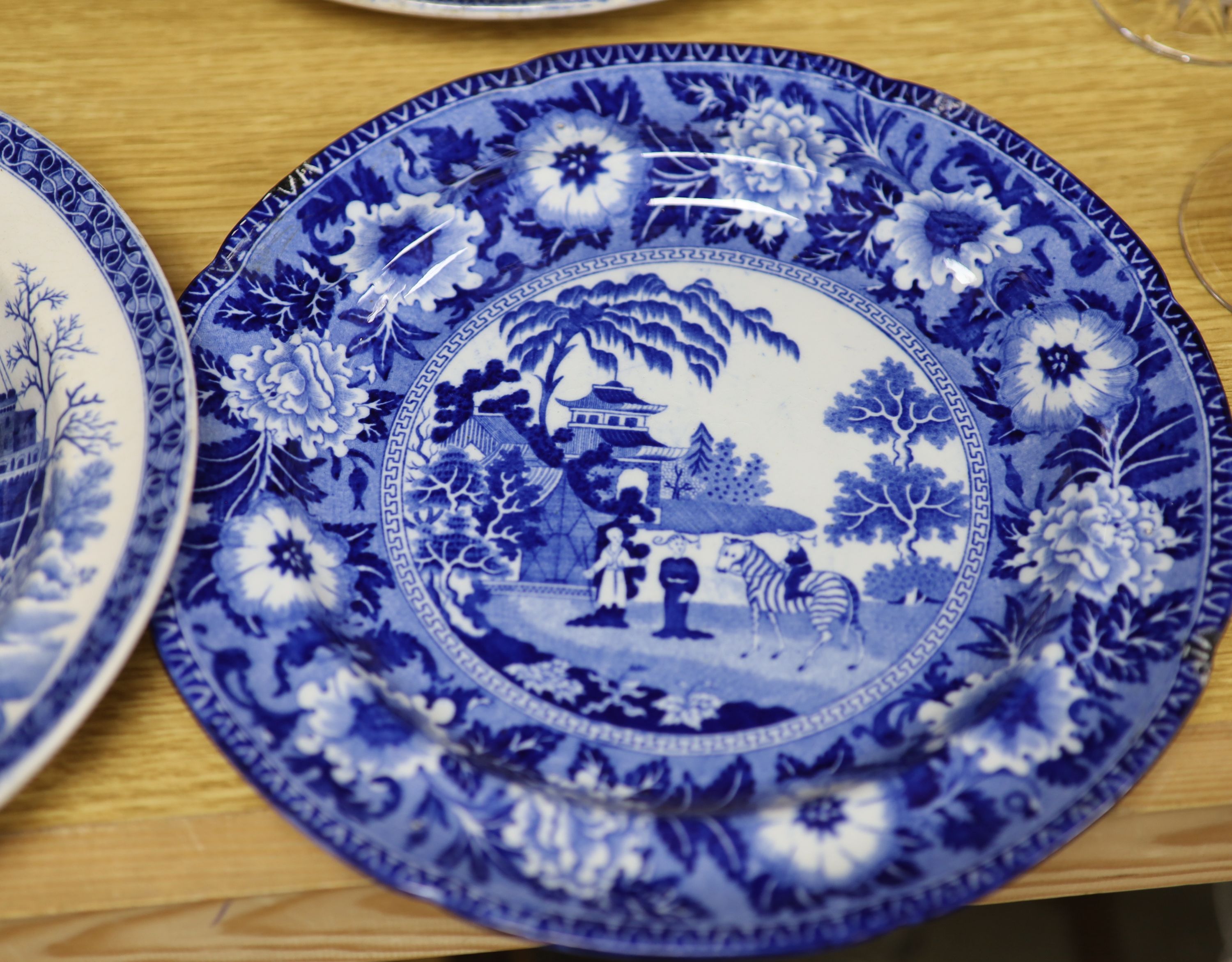 A quantity of 19th century blue and white pottery, including a Harewood House platter, 37cm, and a Spode Rome Tiber soup plate